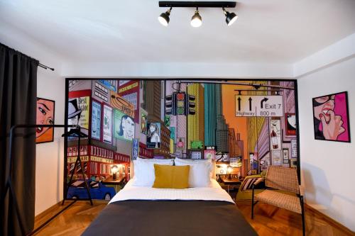 a bedroom with a large bed with a mural of a city at Colorful Chic: Cozy Studio in the Bustling City Center in Bucharest