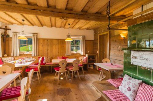 a restaurant with tables and chairs in a room at Wald am See in Kitzbühel