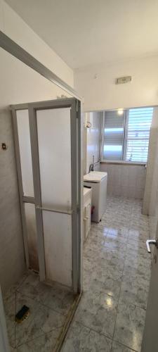 a bathroom with a refrigerator and a sink at City Center in Petaẖ Tiqwa