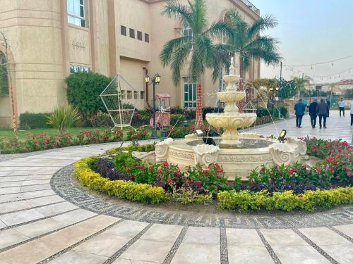 a fountain in a courtyard in front of a building at فندق أورو بلازا ORO Plaza Hotel in Cairo