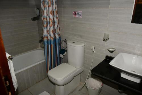 a bathroom with a toilet and a sink at Grand Pyramid View Hotel in Cairo