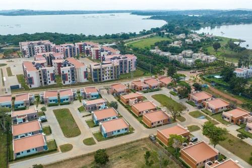 an aerial view of a city with buildings and the water at The Gray Haven Lakeside Condo in Entebbe in Entebbe