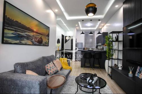a living room with a couch and a table at The Gray Haven Lakeside Condo in Entebbe in Entebbe