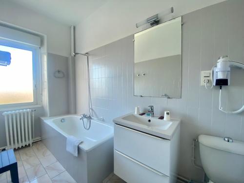 Hotel le Pasteur في رويان: حمام أبيض مع حوض ومرحاض