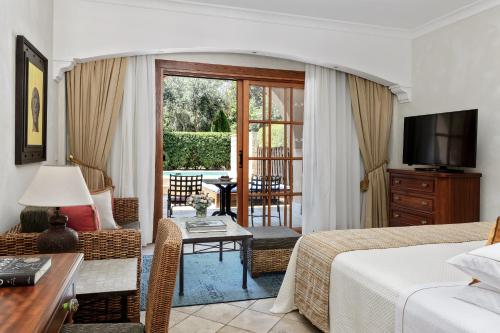 a bedroom with a bed and a living room at Elysium in Paphos