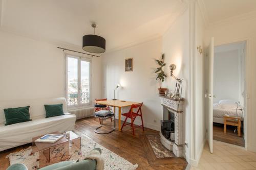 a living room with a couch and a table at Voltaire Cosy appartement au centre de Paris in Paris