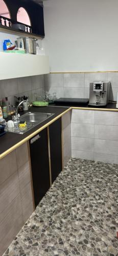 a kitchen with a sink and a counter top at Lala-Lak in Kisújszállás