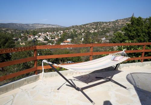 a hammock sitting on a balcony with a view at Despina country retreat in Paphos City