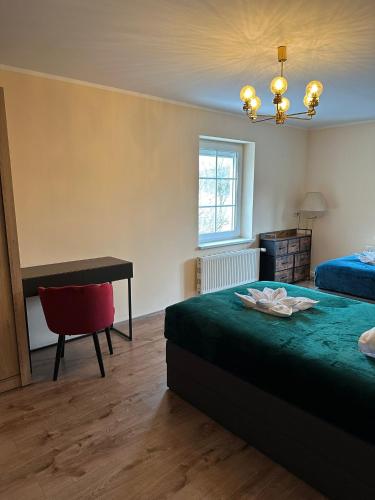 a bedroom with a bed and a desk and a table at Hotel Waldeslust in Kurort Altenberg