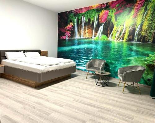 a bedroom with a bed and a painting of a waterfall at Weißes Haus in Plauen
