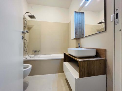 a bathroom with a sink and a toilet at Sebeto Apartment in Naples