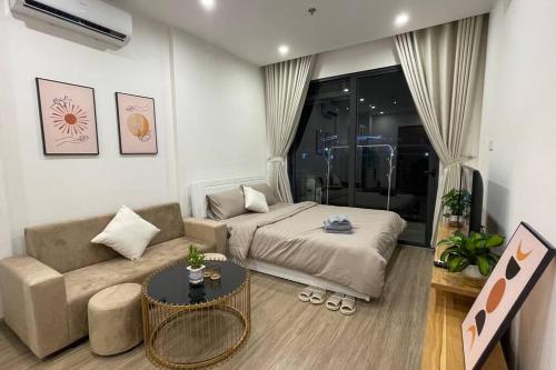 a living room with a bed and a couch at Vinhomes Smart City - Căn hộ Studio cao cấp tại tòa SA3 in Hanoi