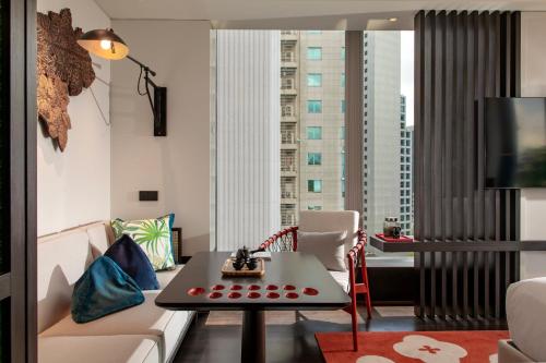 a living room with a couch and a table at Hotel Indigo Kuala Lumpur on the Park by IHG in Kuala Lumpur