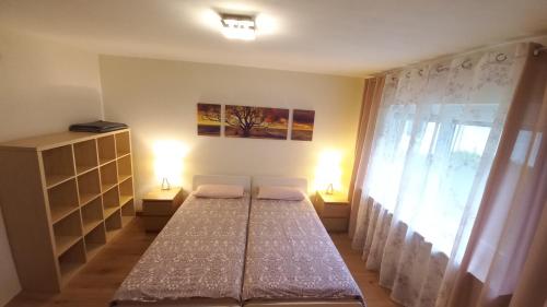 a bedroom with two beds and a window at Holiday Apartment in Oberveischede