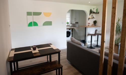 a living room with a couch and a table at Dorset Stylish Apartment in Poole