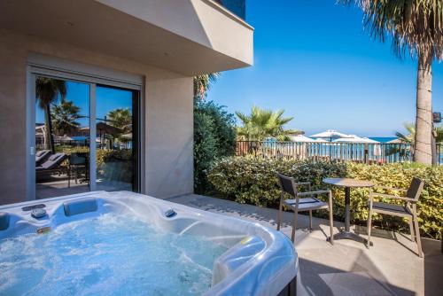 a jacuzzi tub in the backyard of a house at Riviera Boutique Hotel in Stalís