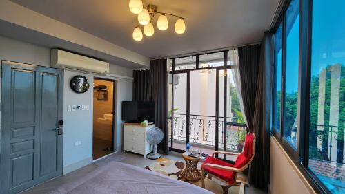 a bedroom with a bed and a balcony with a view at T Home Balcony in Hanoi
