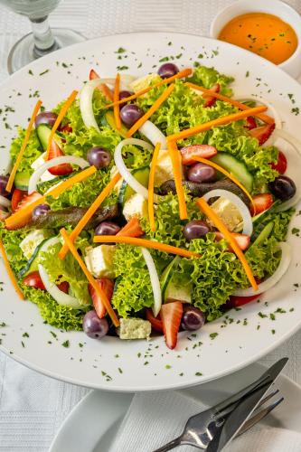 a salad with olives and vegetables on a plate at Calvinia Hotel in Calvinia