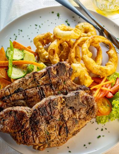 a plate of food with meat and vegetables on a table at Calvinia Hotel in Calvinia