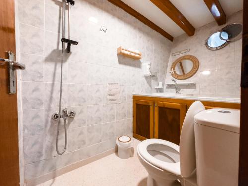 a bathroom with a shower with a toilet and a sink at Seaborn Legend in Fethiye