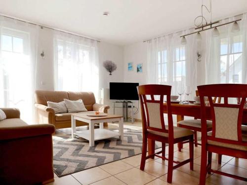 a living room with a couch and a table and chairs at Achtern Diek Whg 07 in Boltenhagen