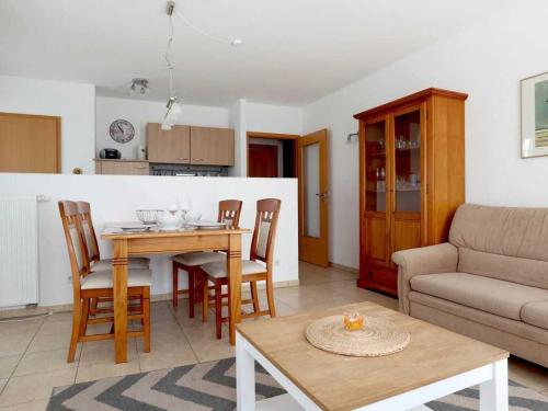 a living room with a table and chairs and a couch at Achtern Diek Whg 07 in Boltenhagen