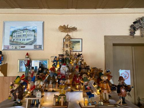 a group of figurines in front of a christmas tree at Hotel Stadt Leipzig in Roßwein