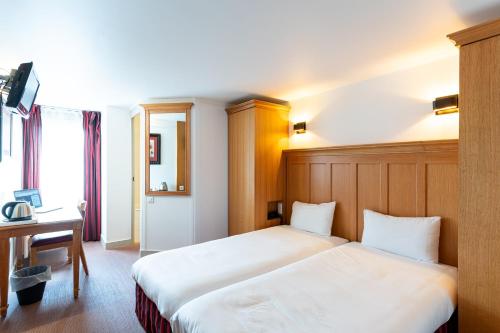 a hotel room with two beds and a desk at KYRIAD CREIL - Chantilly Nord in Creil
