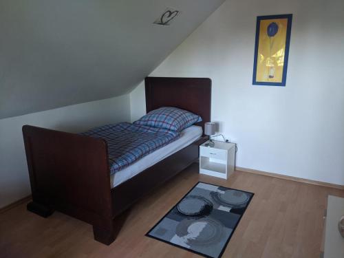 a small bedroom with a bed and a rug at FeWo Wiesenallee OG in Geeste