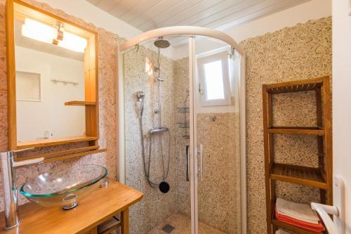 a bathroom with a glass sink and a shower at Maison Isabelle in Plouézec
