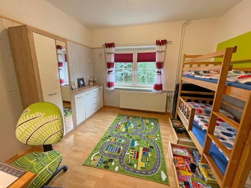 a bedroom with a toy train rug on the floor at Neu Ferienwohnung Kriesten in Bad Brambach