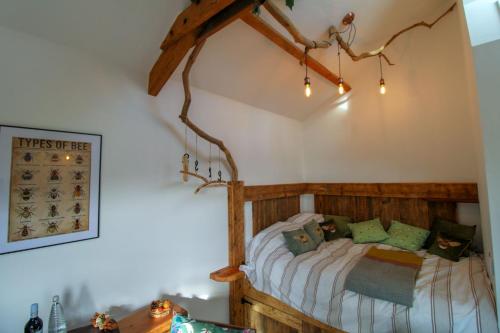 a bedroom with a wooden bed in a room at The Beehive Warton in Warton