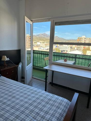a room with a bed and a window with a view at El Campello Mountain View in El Campello