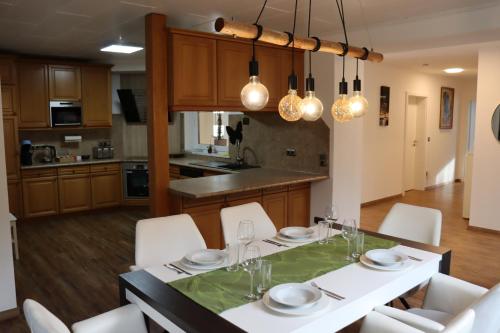 a kitchen and dining room with a table and chairs at Luxury Apartment near Munich Airport - Therme ED - Parking in Berglern