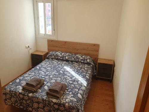 - une chambre avec un lit et 2 serviettes dans l'établissement 4H, Aire Acondic, 50m2, 1 dormitorio, 4 huéspedes, WIFI GRATIS, à La Línea de la Concepción