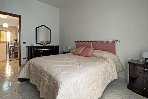 a bedroom with a large bed and a mirror at Domus near Scavi di Poppea in Torre Annunziata