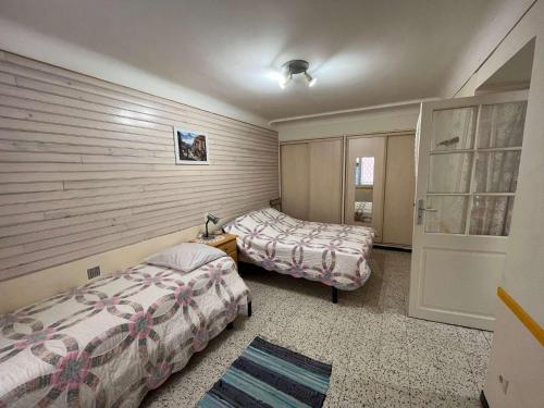 - une chambre avec 2 lits et une porte dans l'établissement 3LIB7 - au cœur du faubourg de Collioure appartement pour 3 personnes, à Collioure