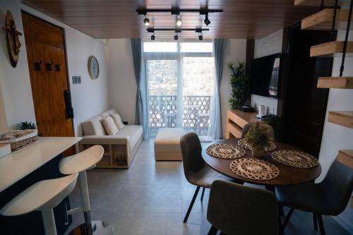 a small living room with a table and chairs at Tinker's Cabin Baguio in Baguio