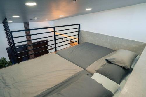 a bedroom with two beds on a balcony at Tinker's Cabin Baguio in Baguio