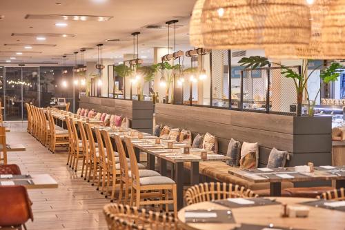 a row of tables and chairs in a restaurant at Hotel Florida Magaluf - Adults Only in Magaluf
