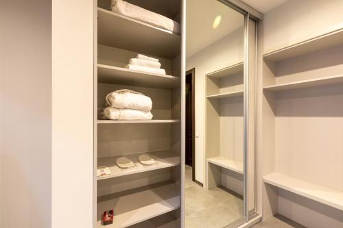 a walk in closet with a mirror and towels at Hotel-Restaurant Complex Vensky in Brovary