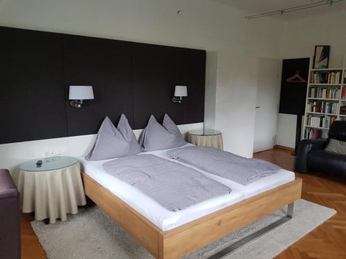 a bedroom with a large bed with a black wall at Gästehaus Grogger in Weyer Markt