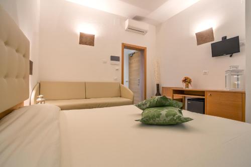 a room with a bed and a couch at Hotel Il Buongustaio in Massa