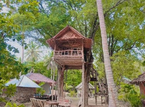 a tree house in the middle of a forest at Sunset Beach Bungalow Koh Pu in Ko Jum