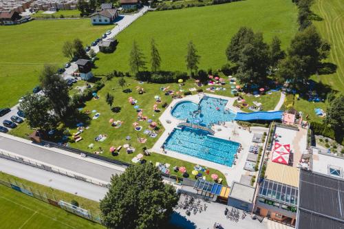 an aerial view of a resort with a swimming pool at Our's Living - modern Apartments with Sauna near Kitzbüheler Alpen ski lift in Hollersbach im Pinzgau