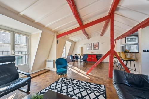 an attic living room with red and white ceilings at Latin Quarter & Sorbonne - CityApartmentStay in Paris
