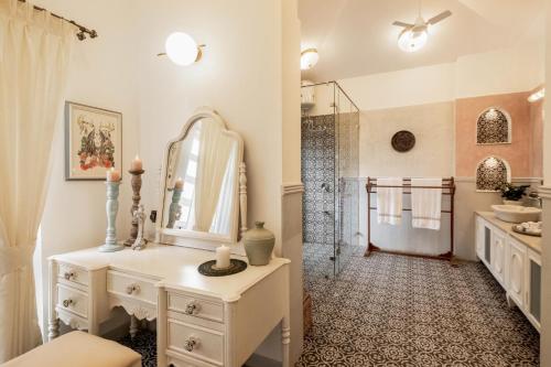 a bathroom with a white vanity and a shower at LohonoStays Castello Villa 5 in Vagator
