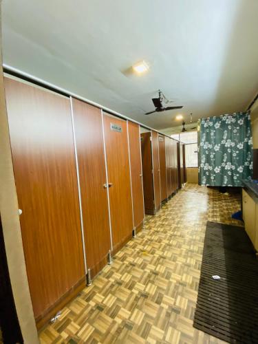 a hallway with wooden lockers in a building at Homestay Ac Dormitory in New Delhi