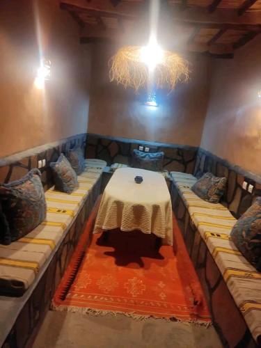 a room with a table in the middle of a room at La perle de saghro in Nkob