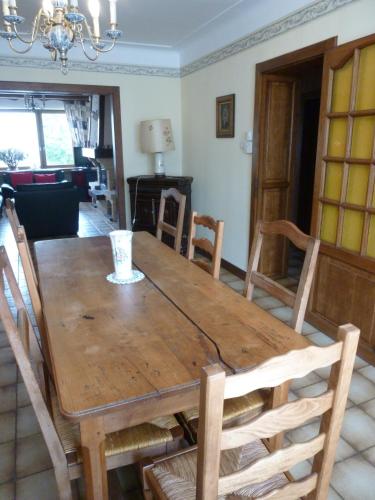 a wooden table and chairs in a living room at Les Chambres De Solgne in Solgne